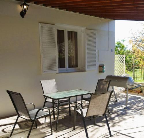 a table and chairs sitting on a patio at Lihas House in Agios Georgios
