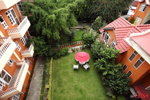 an overhead view of a garden with a red table and chairs at Melungtse apartment in Kathmandu