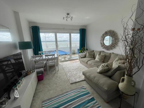 a living room with a couch and a table at Sandbanks, Poole Harbour in Sandbanks