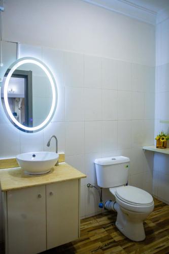 a bathroom with a white toilet and a sink at LEKKI SECRET MANSION 'n' SWIMMING POOl in Aja