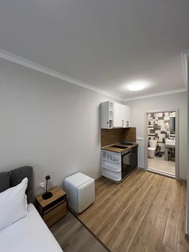 a bedroom with a bed and a kitchen with a counter at GREEN PARK Apartments and rooms for guests in Asenovgrad