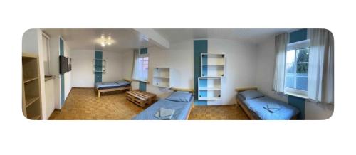 a room with two beds and a couch in it at Zimmer 5 in Bullendorf