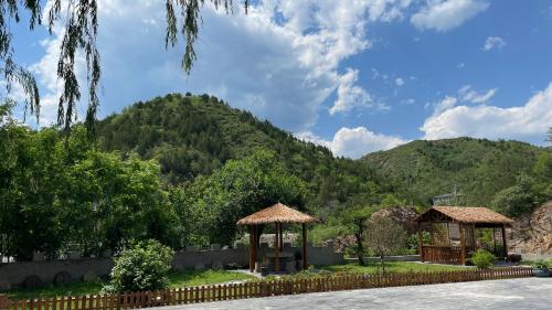 a view of a mountain with a gazebo at 古北御尚精品民宿Gubeiyushang in Gubeikou