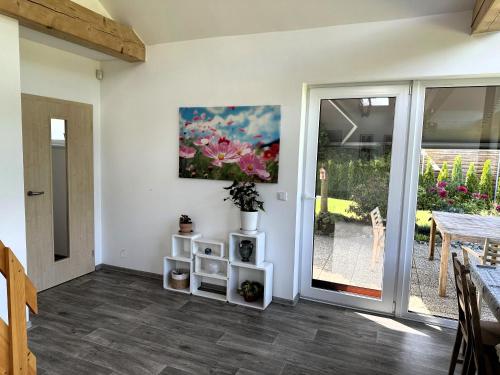 a living room with a table and a painting on the wall at Vila u potoka in Jindrichuv Hradec