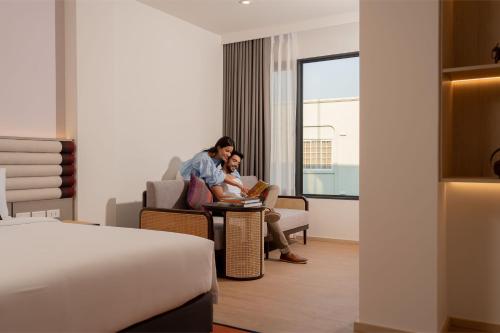 two people sitting at a table in a hotel room at Pranakorn Heritage Hotel in Bangkok