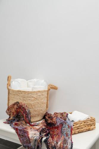 a basket of white towels on a table at Hotel Theopisti in Ouranoupoli