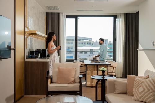 a man and a woman standing in a hotel room at Pranakorn Heritage Hotel in Bangkok