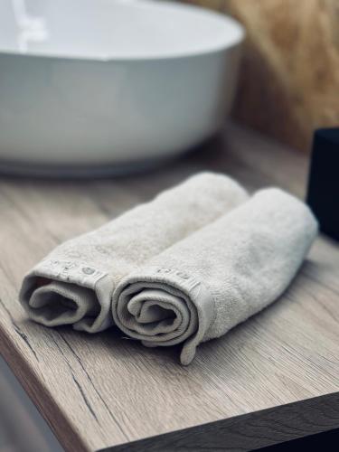 a pile of towels sitting on a table in a bathroom at Glamping Salaš in Mochtín