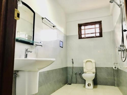 a bathroom with a sink and a toilet at Ella Jayamali Holiday Pavilion in Ella