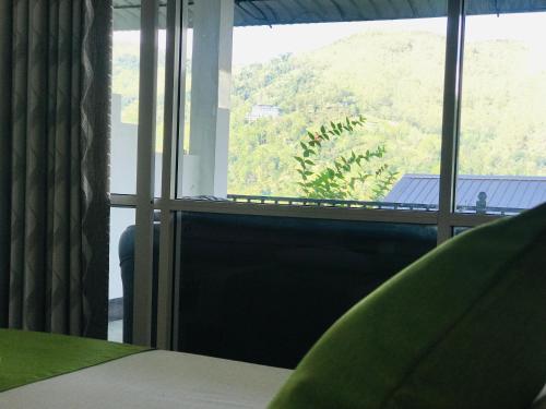 a room with a window with a view of a mountain at Ella Jayamali Holiday Pavilion in Ella