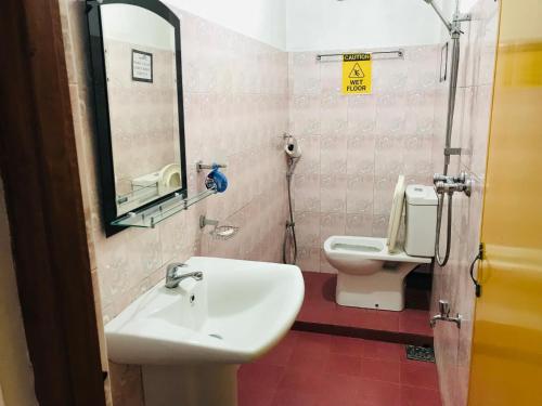 a bathroom with a sink and a toilet at Ella Jayamali Holiday Pavilion in Ella