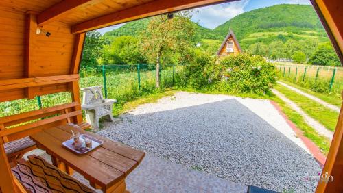 a porch of a cabin with a table and a bench at Pyramid Energy House in Visoko