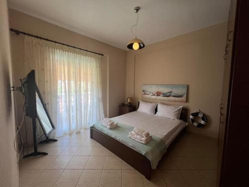 a bedroom with a bed with towels on it at Sea & Sun Retreat in Nea Vrasna