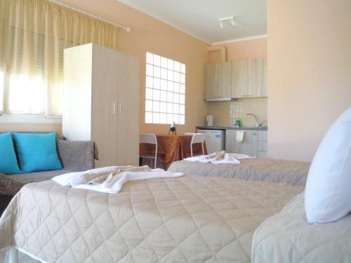 a large room with two beds and a kitchen at Bright Sea - Studios in Limenas