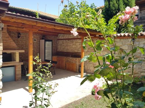 a patio of a house with a stone wall at Villa Nikoli in Nesebar