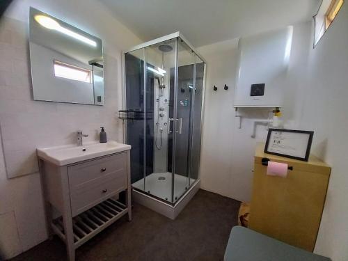 a bathroom with a glass shower and a sink at La Bulle des alpagas in Herry