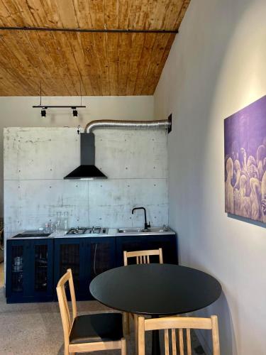 cocina con mesa negra y fregadero en Twins Guest House, en Telavi