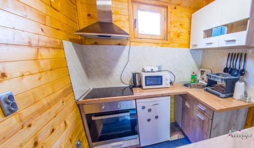 a small kitchen with a stove and a microwave at Pyramid Energy House in Visoko