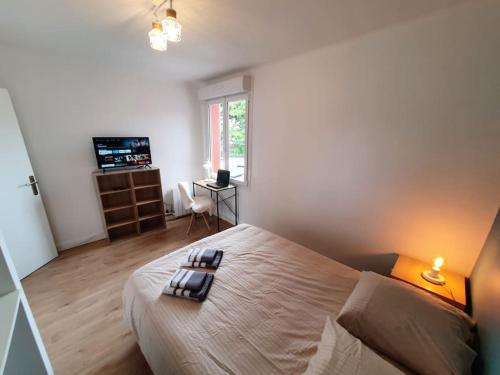 une chambre avec un lit avec deux serviettes dessus dans l'établissement LE PROVENCE I Neuf I 2 chambres I Proche Mer I Wifi haut débit, à Saint-Brieuc