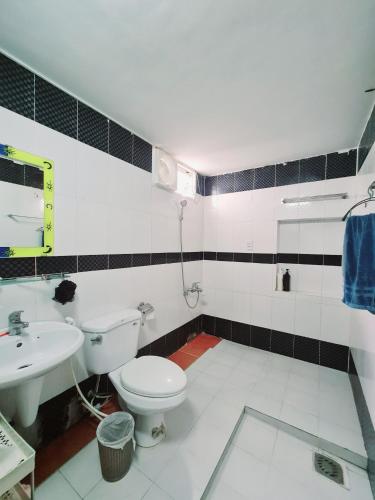 a bathroom with a toilet and a sink at Myths Saigon in Ho Chi Minh City