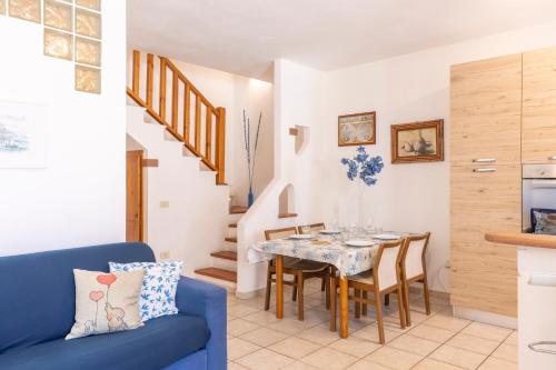 a kitchen and dining room with a table and chairs at Casa Calasetta sul porto in Calasetta