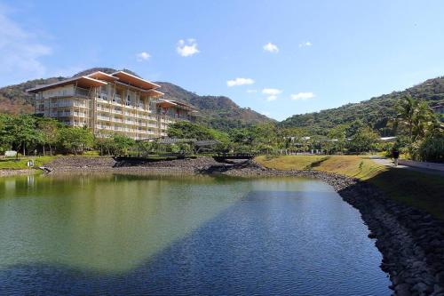 a building with a bridge over a body of water at Sunset Room at Pico - Hamilo Coast Pico De Loro in Nasugbu