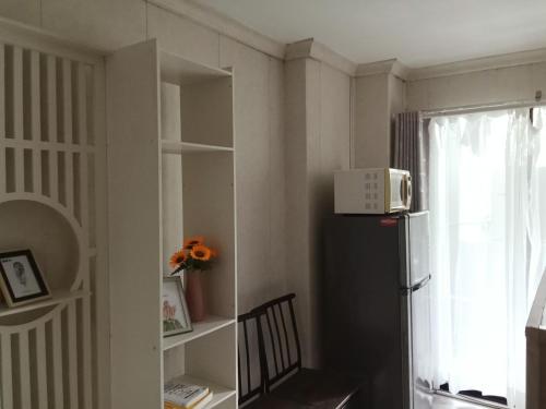 a kitchen with a black refrigerator and a window at Morning cozy, airport 5-30 min in Pak Kret