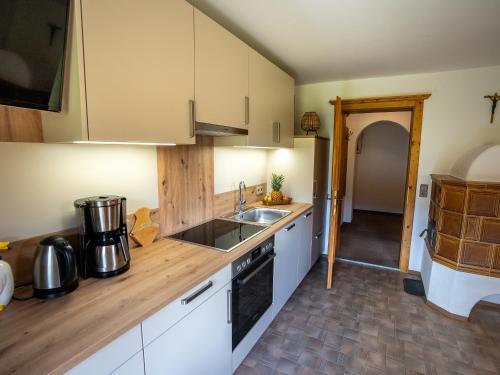 a kitchen with a sink and a counter top at Haus Schatzbergblick in Oberau