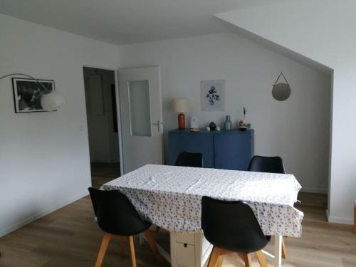 une table à manger avec quatre chaises et une armoire bleue dans l'établissement T2 58M2, proche Orly et Disney, parking, ligne métro 8 à 5 minutes, à Créteil