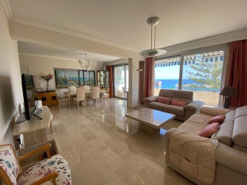 a living room with couches and a dining room at Alania Sea View Apartment in Limassol