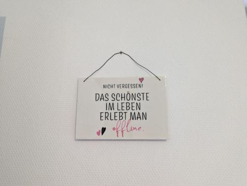 a sign hanging on a wall with the words mum wasassociation das sadness at Ferienwohnung Philippi - Moselblick mit großer Dachterrasse, 75 qm, Hunde willkommen in Mehring