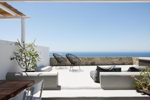 a patio with two chairs and a couch at Boho Origin Mykonos in Mýkonos City