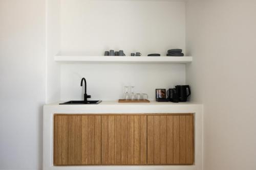 a kitchen with a counter with a wooden door at Boho Origin Mykonos in Mýkonos City