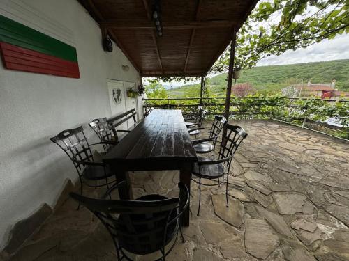 a wooden table and chairs on a patio at Villa MAKA - Balchik, Albena Village Zone in Balchik
