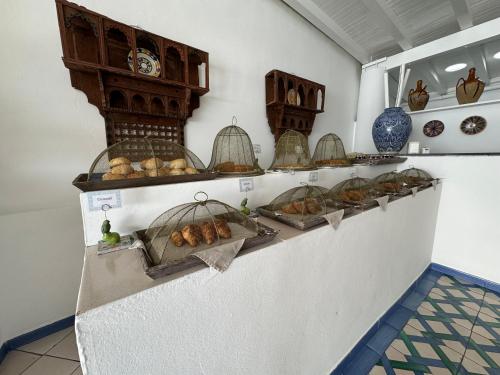 a shelf with many birds in cages on it at Hotel Lisca Bianca in Panarea
