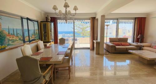 a living room with a dining table and a couch at Alania Sea View Apartment in Limassol