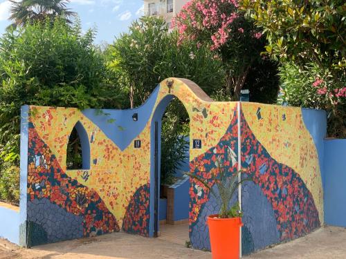 a colorful gate with a plant in a pot at Maroccana in Dobra Voda