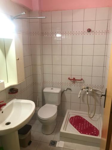 a bathroom with a toilet and a sink at Thomas Vrasna Close To The Sea in Nea Vrasna