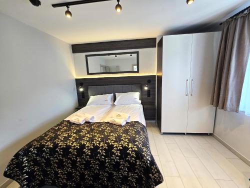 a bedroom with a bed and a mirror on the wall at Słoneczny Brzeg - Apartamenty w Pieninach in Krościenko