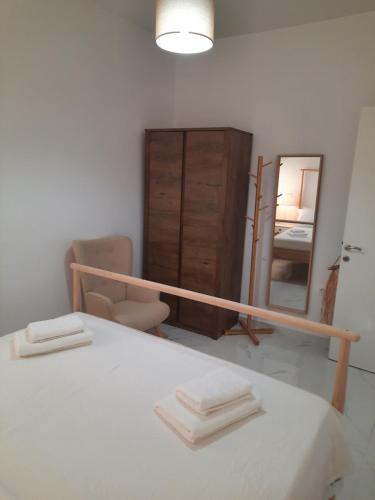 a bedroom with a bed with a mirror and a dresser at House B Diavata, Thessaloniki in Thessaloniki