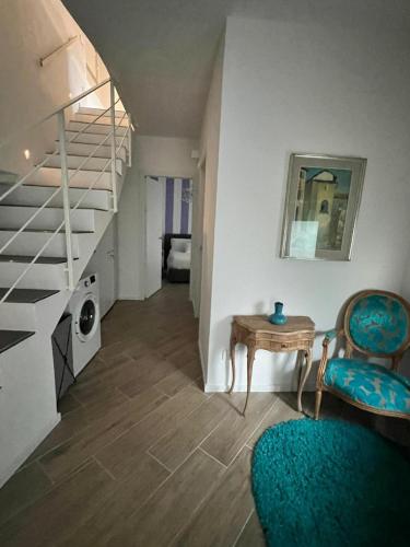 a room with a staircase and a table and chairs at Casa Amelia in Nesso