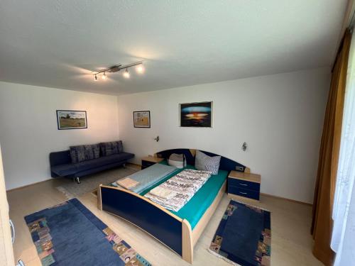 a small bedroom with a bed and a couch at Zell Views Apartments in Zell am Ziller