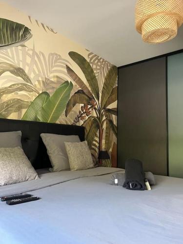 a bedroom with a large bed with a painting on the wall at Villa avec piscine chauffée in Ancy