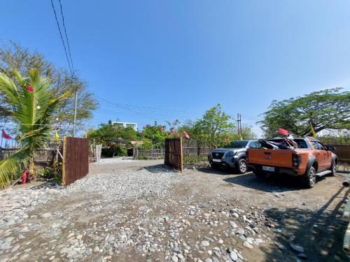 a couple of cars parked in a gravel parking lot at Cristy's Place in Luna