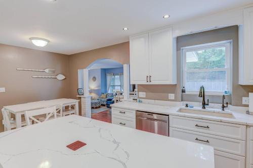 a kitchen with white cabinets and a white counter top at Lighthouse Seclusion in Ocean Pines