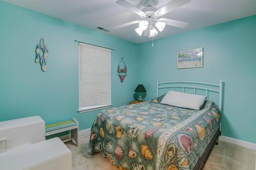 a bedroom with a bed and a ceiling fan at Lighthouse Seclusion in Ocean Pines