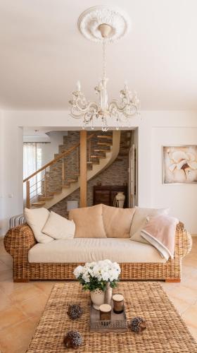 a living room with a couch and a chandelier at Villa Bella Elana in Jūrmala
