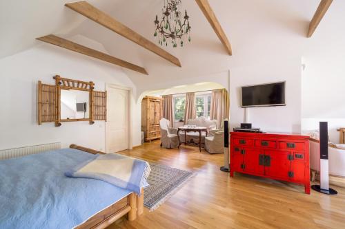 a bedroom with a blue bed and a red dresser at Villa Bella Elana in Jūrmala