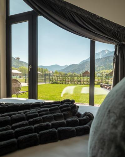 a bedroom with a large window with a view at Luxury Aframe in Râşnov
