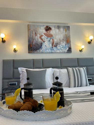 a table with a tray of food on a bed at Golden moments Luxury Stone Villas A in Mesaria